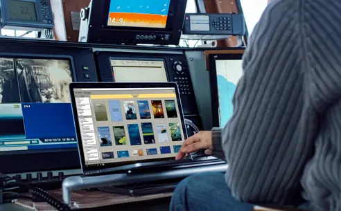 Person using SeaReader on a laptop in a control room
