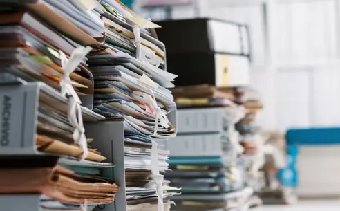 Stacks of a lot of files and folders in an office