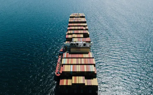 Above view of container ship in the blue sea