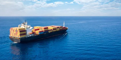 A large container ship navigating across the ocean