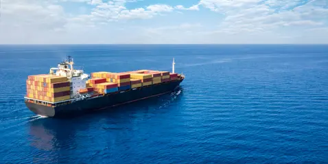 A large container ship navigating across the ocean