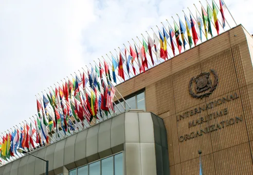 Front of the IMO Headquarters building with flags from all countries