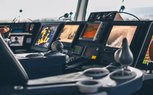 Controls and monitors on bridge of ship